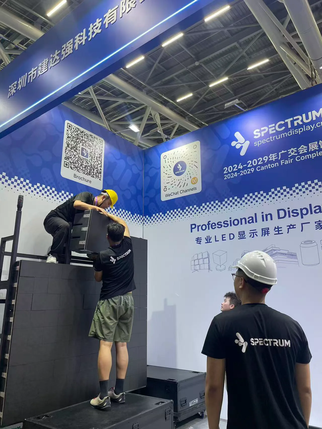Spectrum Display booth construction in progress at the Canton Fair — engineers assembling LED cabinets at Booth 19.2A06-07, Hall 19.2