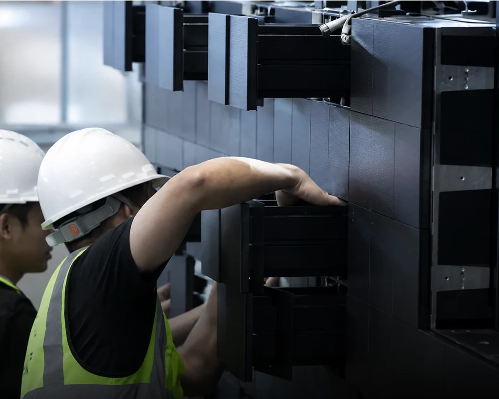 Technician performing front maintenance on an indoor kinetic LED module